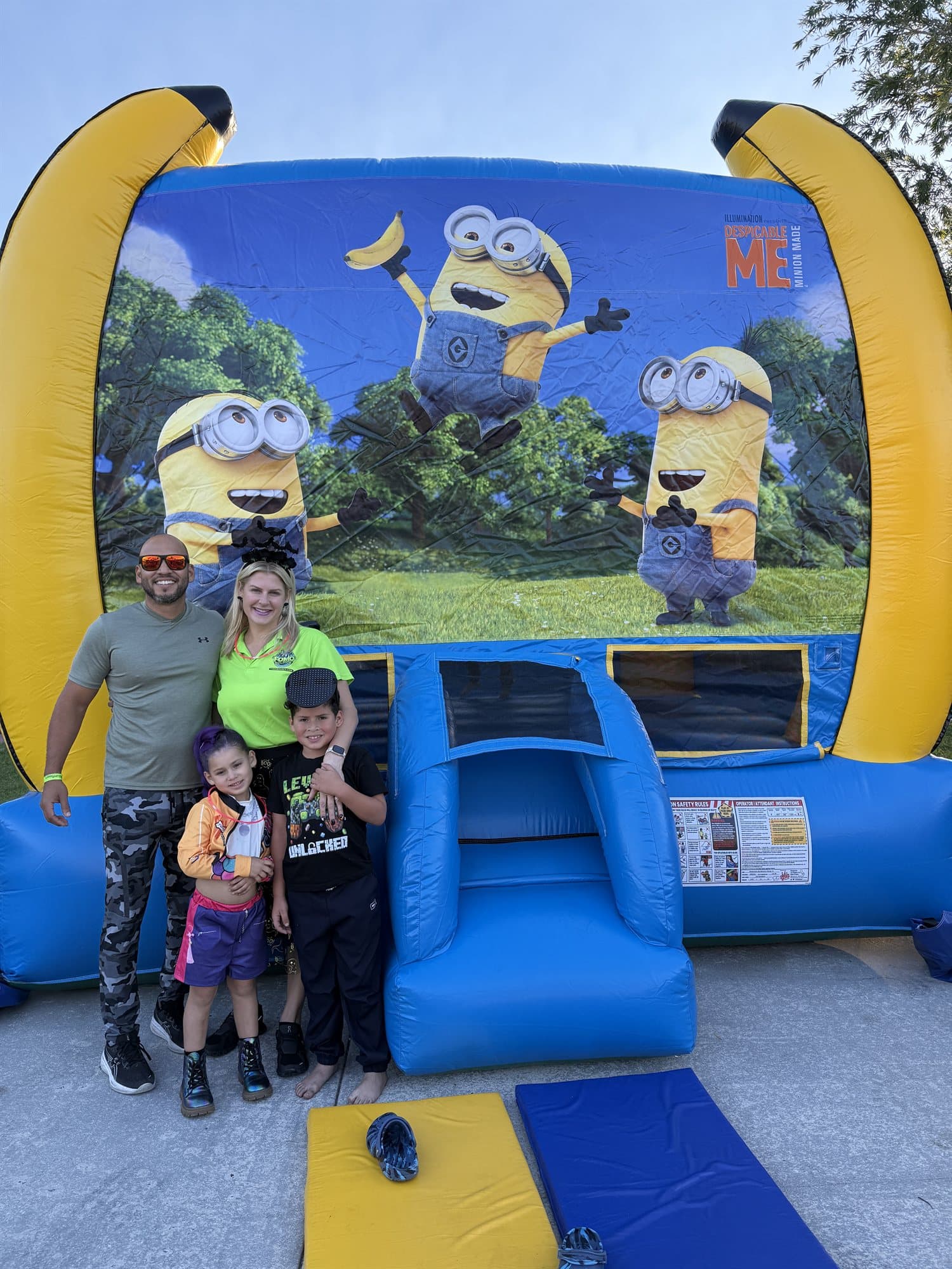 The FOMO Bounce family with one of our bounce houses